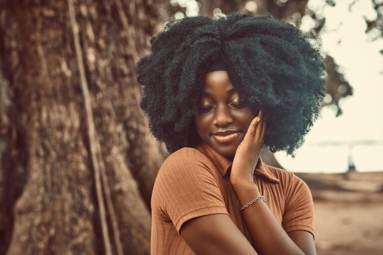 Woman with long, healthy afro hair after using chebe powder